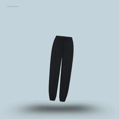 SKIMS Sleep Balloon Pant in Onyx, flat lay on light blue background