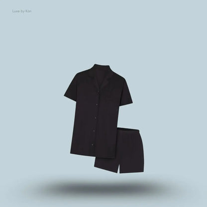 SKIMS Sleep Short Sleeve Button Up Set in Onyx, flat lay on light blue background