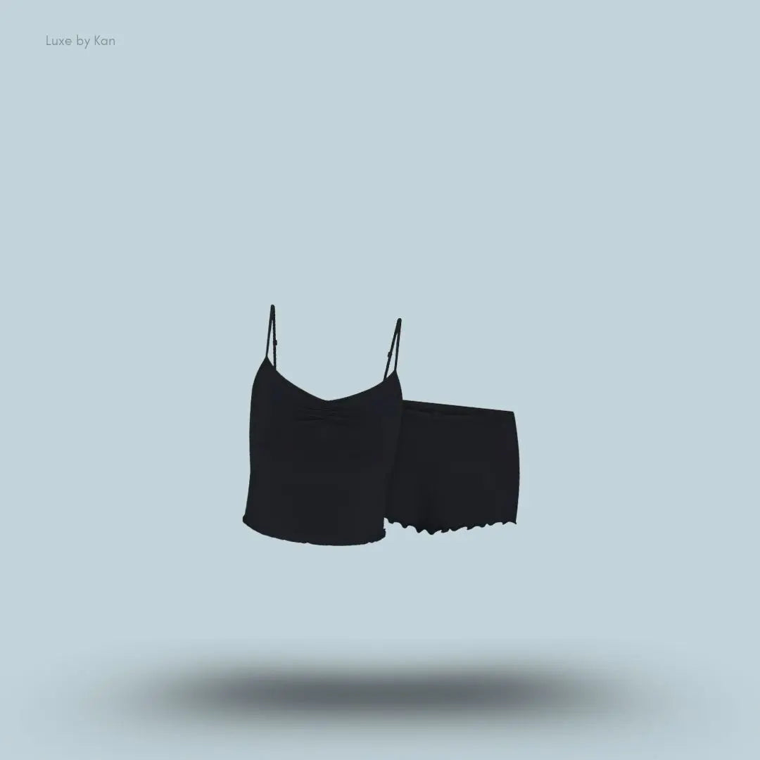 SKIMS Sleep Cami Set in Onyx, flat lay on light blue background