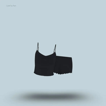 SKIMS Sleep Cami Set in Onyx, flat lay on light blue background
