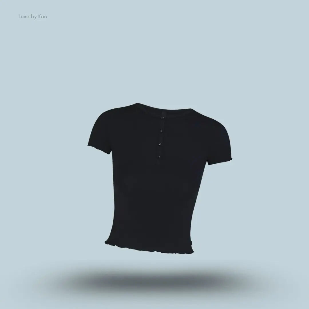 SKIMS Sleep Henley and Foldover Short Set henley top in Onyx, flat lay on light blue background