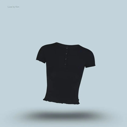 SKIMS Sleep Henley and Foldover Short Set henley top in Onyx, flat lay on light blue background