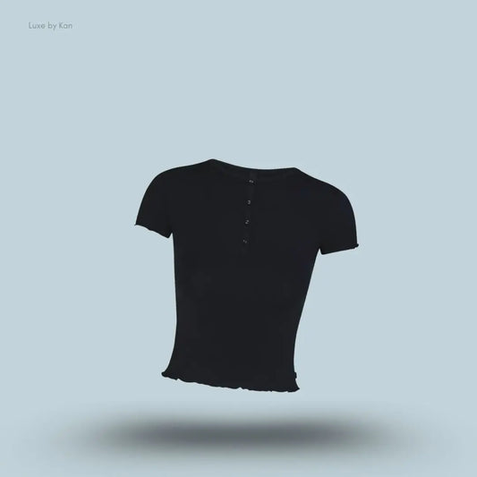 SKIMS Sleep Henley and Foldover Short Set henley top in Onyx, flat lay on light blue background