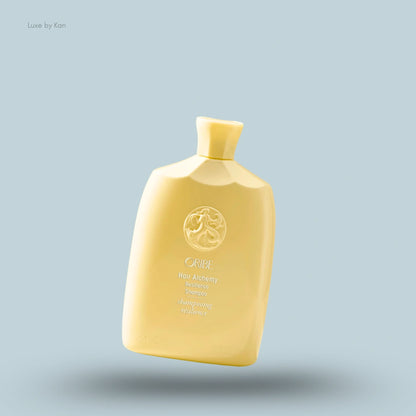 Oribe "Hair Alchemy Resilience Shampoo" in a yellow bottle with the brand's logo on a blue background.