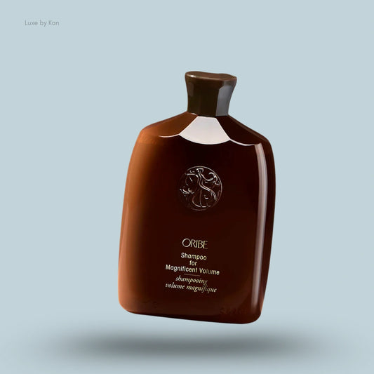 Brown Oribe shampoo bottle with "Shampoo for Magnificent Volume" label.