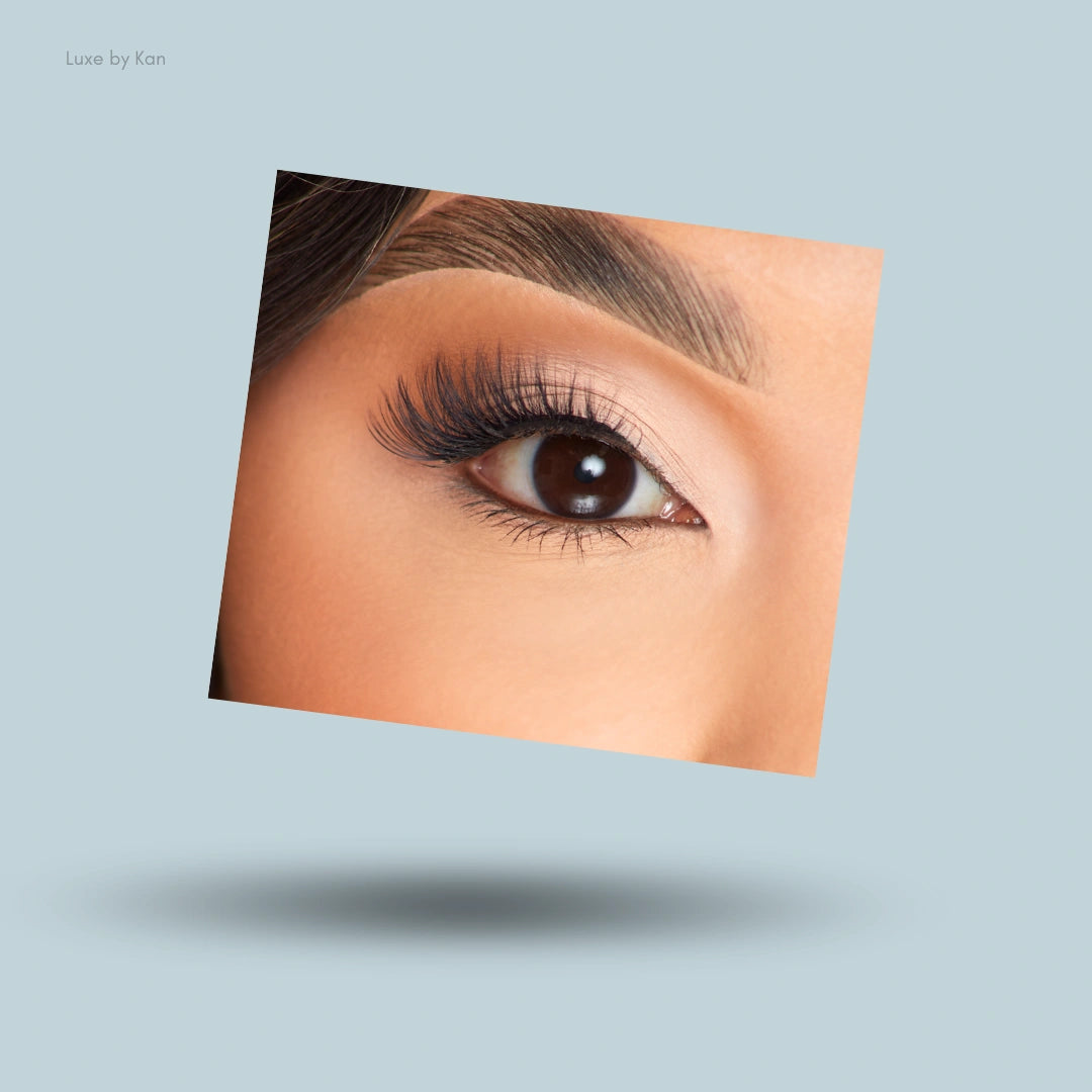 A close-up of a person wearing P.Louise Heavenly Half Lashes on one eye, featuring long and wispy dark lash fibers.