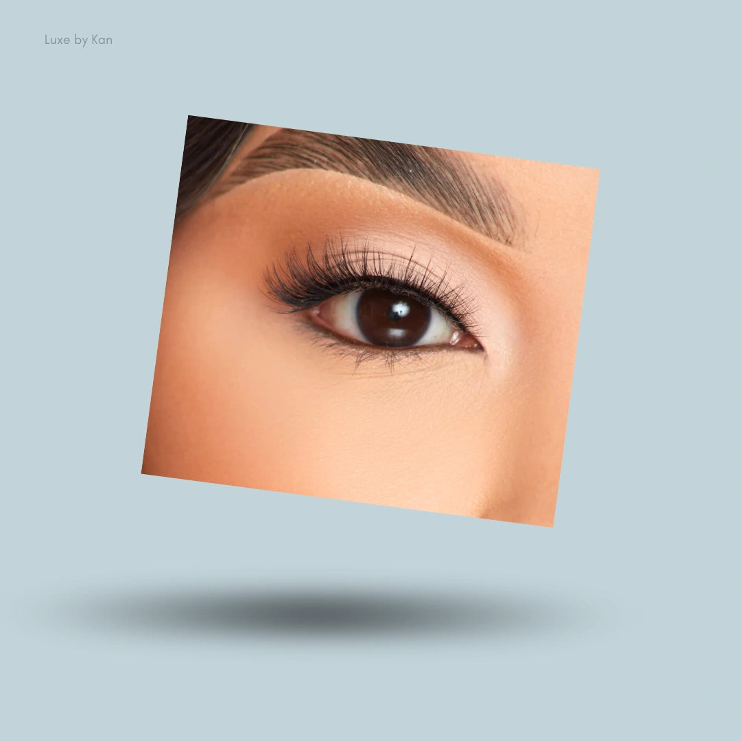 A close up of an eye showing the long and fluttery P.Louise So Graceful Angel Lashes against a soft light blue background.