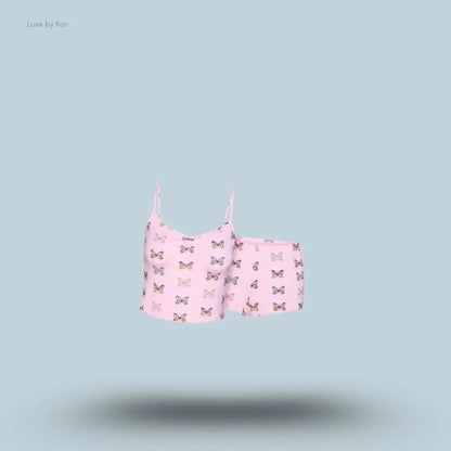 SKIMS Sleep Cami Set in Peony Butterfly Print, flat lay on light blue background