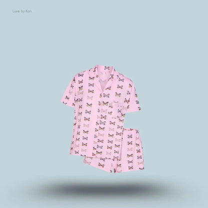 SKIMS Sleep Short Sleeve Button Up Set in Peony Butterfly Print, flat lay on light blue background