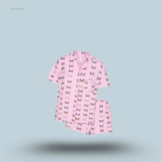 SKIMS Sleep Short Sleeve Button Up Set in Peony Butterfly Print, flat lay on light blue background