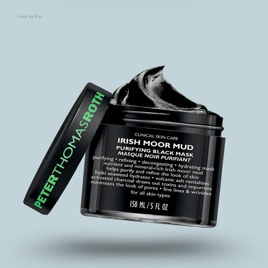 Peter Thomas Roth Irish Moor Mud Purifying Black Mask in a black jar with a dollop of black mud overflowing, with the lid next to the jar.