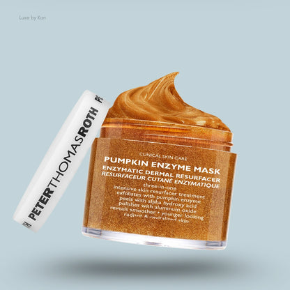 Peter Thomas Roth Pumpkin Enzyme Mask in an opened jar, revealing a thick, golden, shimmery textured mask. The jar’s label indicates it's a clinical skincare product and an enzymatic dermal resurfacer. The white lid is adjacent to the jar.