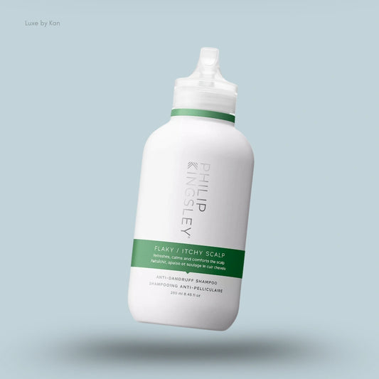 White bottle of Philip Kingsley flaky/itchy scalp anti-dandruff shampoo with a green label and a clear dispensing cap.