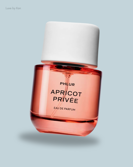 A stylish bottle of Phlur Apricot Privée Eau de Parfum with a white cap.
