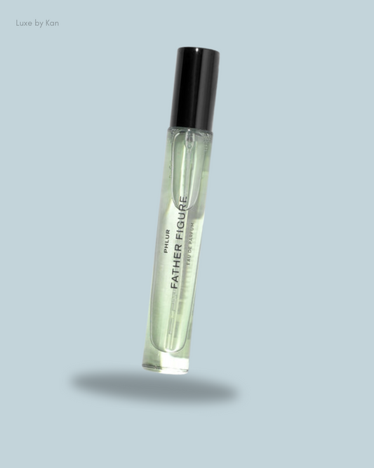 A floating bottle of Phlur Father's Figure Eau de Parfum, featuring a sleek design with a black cap and light green liquid.