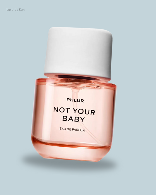 A bottle of PHLUR's "Not Your Baby" Eau de Parfum with a white cap.