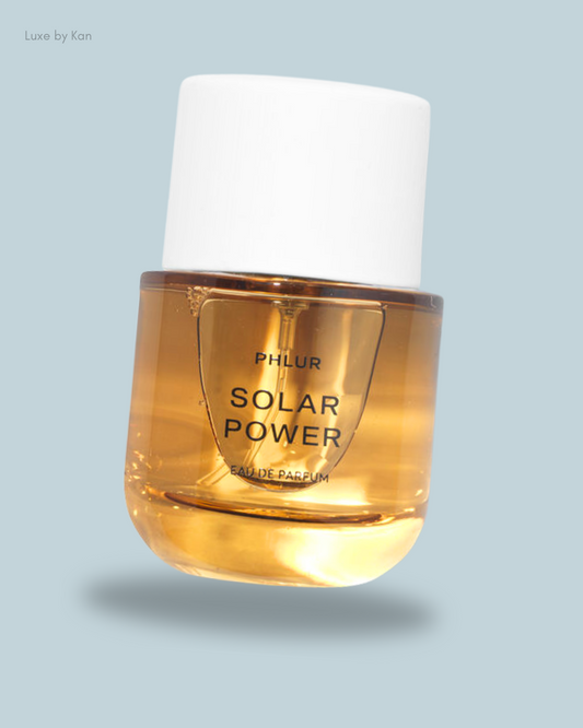 Bottle of Phlur's Solar Power fragrance, featuring a clear glass base with a white cap.