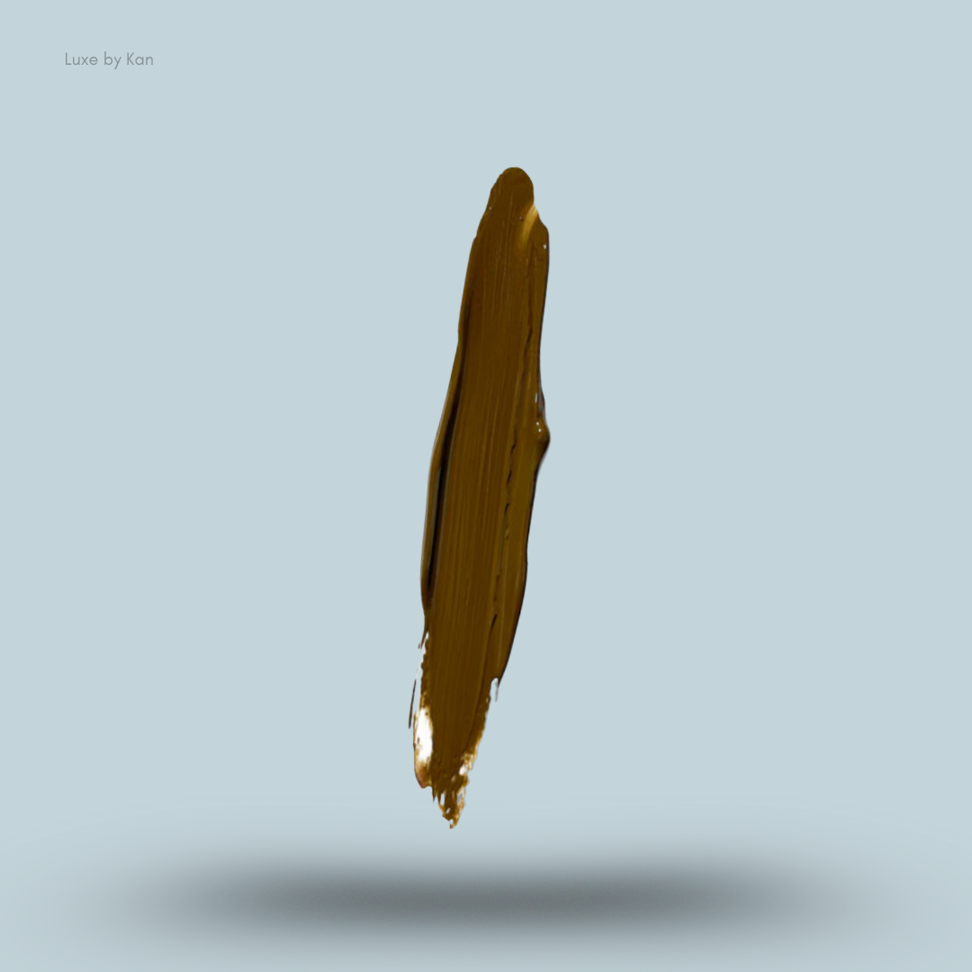 A single smear of brown Plouise coloured base makeup floating above a shadow on a light blue background.