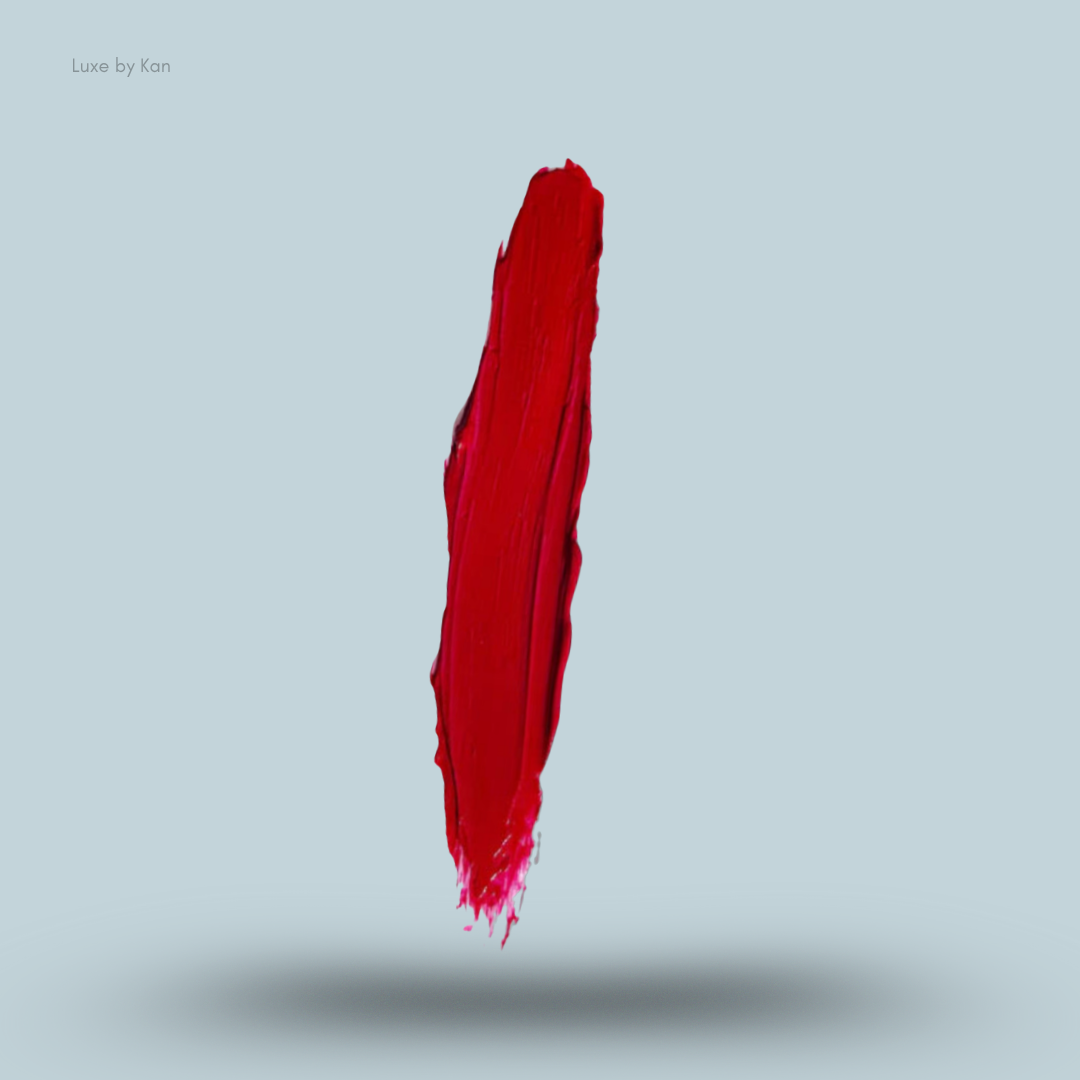 Vertical smear of Plouise red-pigmented color base against a light blue background, casting a soft shadow.