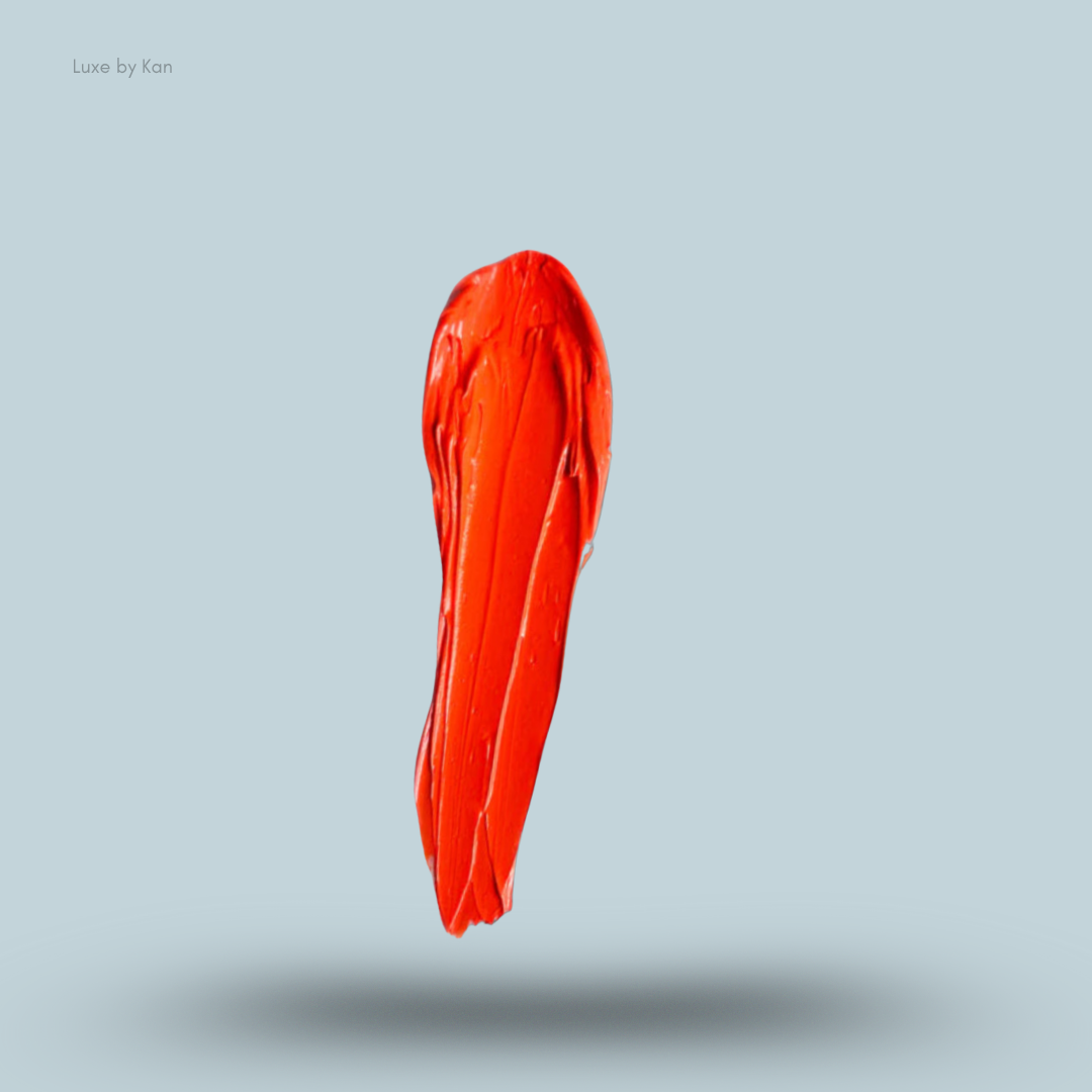 Vertical stroke of vibrant orange Plouise coloured base against a pale blue background, casting a soft shadow.