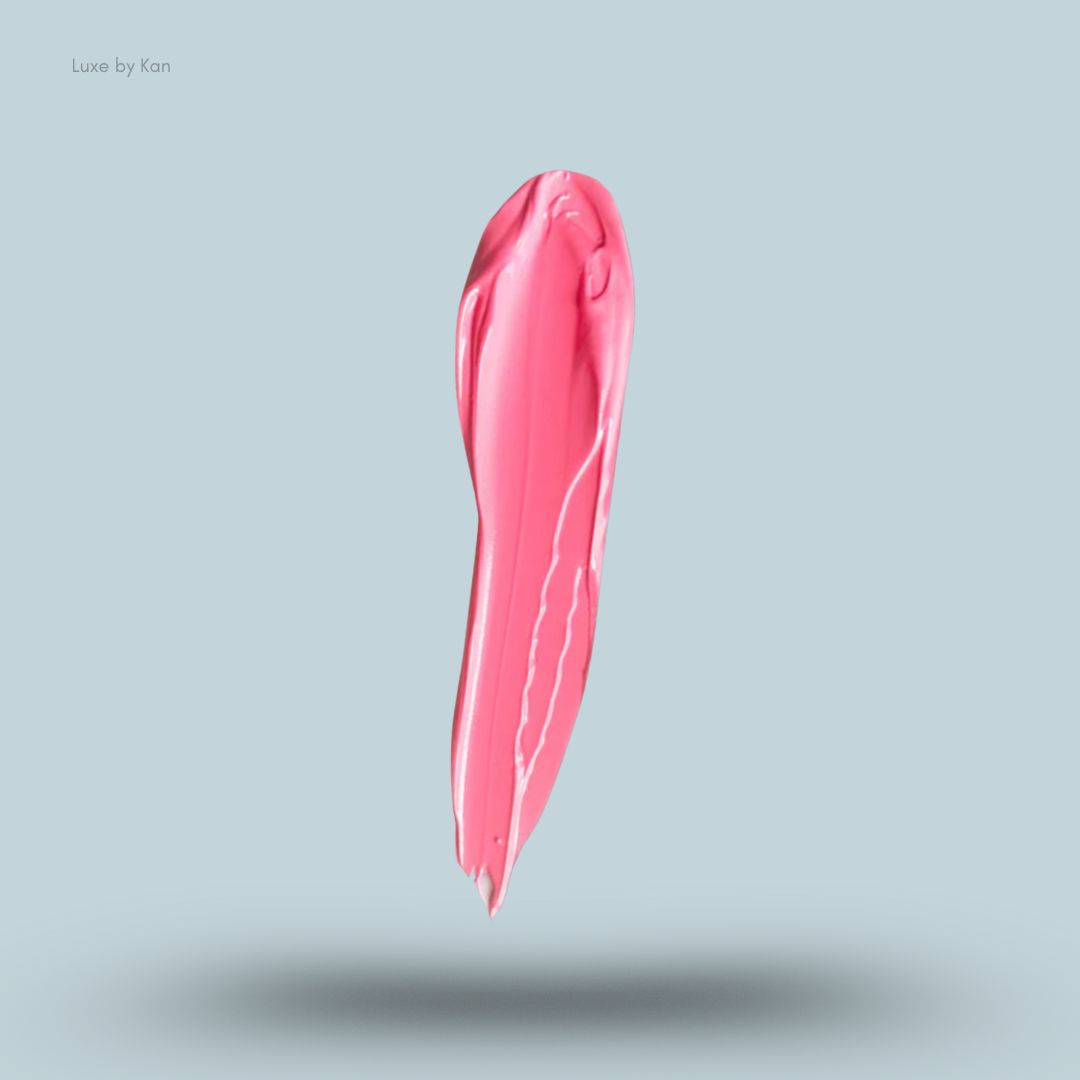 Close-up of a single, vertical smear of pink Plouise coloured base against a plain blue background.