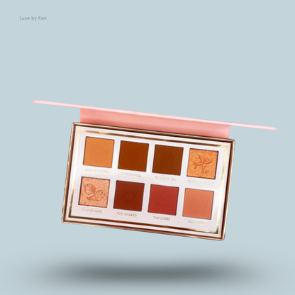 Close-up of the open Plouise Love Tapes palette in "Baecation" with eight shades of eyeshadow in warm, brown, and orange tones.