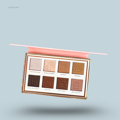 Close-up of a Plouise Love Tapes Beneath The Sheets eyeshadow palette, featuring eight shades with embossed designs and names.