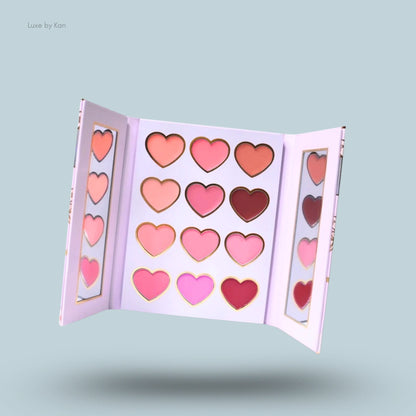 Open lip palette featuring 16 heart-shaped shades in pinks and nudes, with a sleek design and elegant gold detailing.