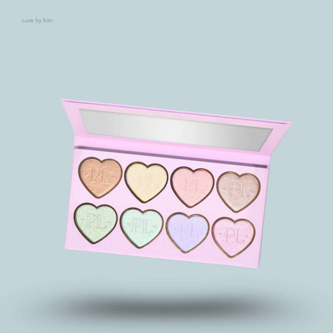 Open pink Plouise Wrap It Up highlighter palette with eight heart-shaped pans; shades include peach, yellow, pink, champagne, green,mint, lavender, and rose.