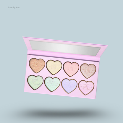Open pink Plouise Wrap It Up highlighter palette with eight heart-shaped pans; shades include peach, yellow, pink, champagne, green,mint, lavender, and rose.