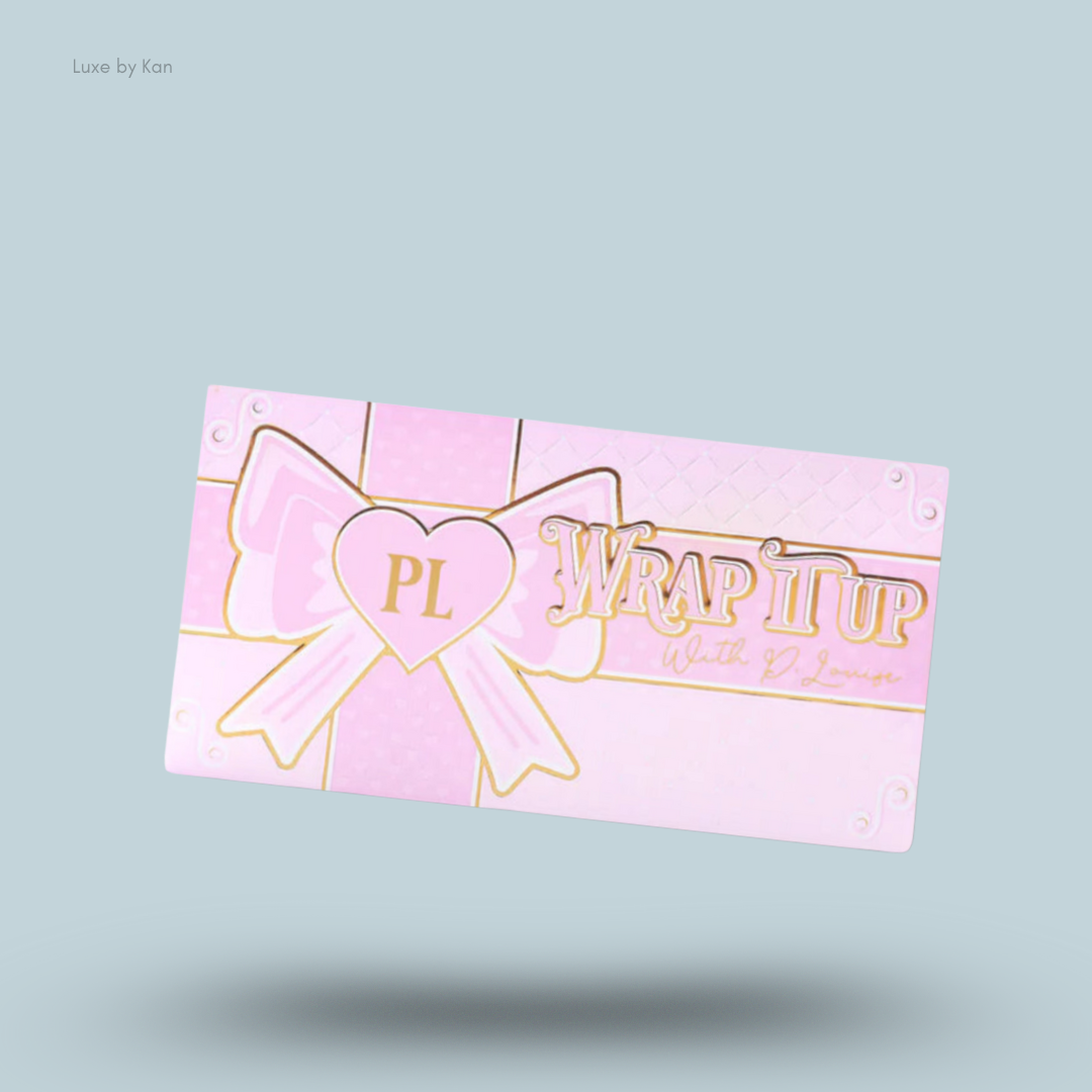 Pink and gold Plouise "Wrap It Up" highlighter palette with a bow design and heart-shaped logo.