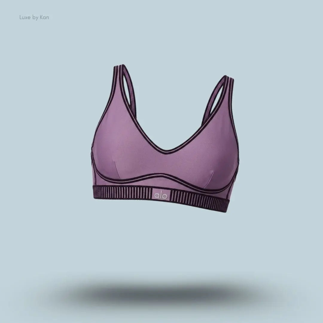 Alo Airlift Line Up Bra in Plum Kiss, flat lay on light blue background