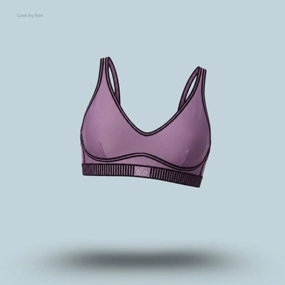 Alo Airlift Line Up Bra in Plum Kiss, flat lay on light blue background