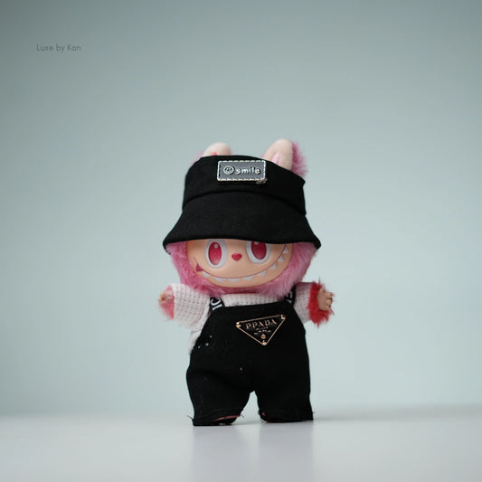 Pink Labubu doll in black Prada overalls and black bucket hat.