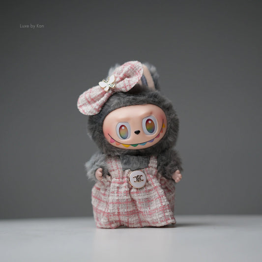 Pop Mart Labubu doll with gray fur and pink tweed dress and bow.