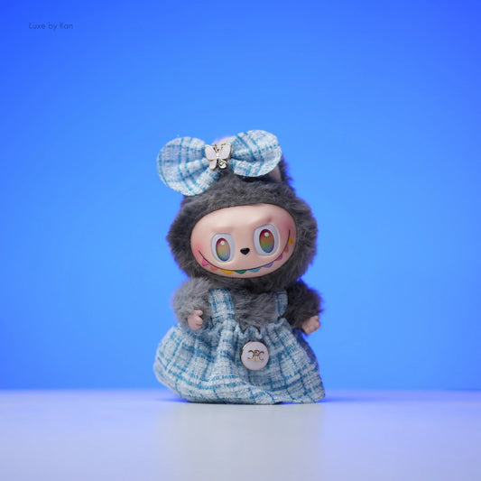 Labubu doll in a tweed dress outfit with a bow.