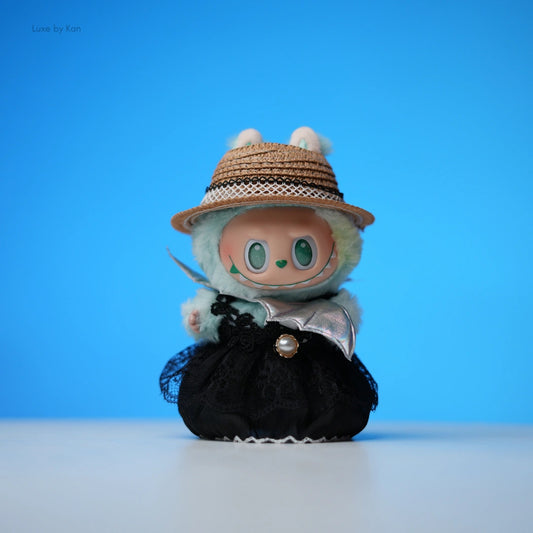 Labubu doll wearing vintage-style picnic outfit, including a straw hat and a lace-trimmed black dress.