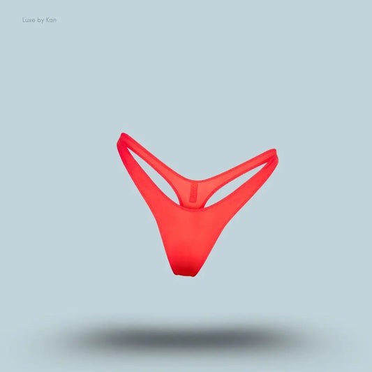 SKIMS Shine Foundations Dipped Thong in Poppy, flat lay on light blue background