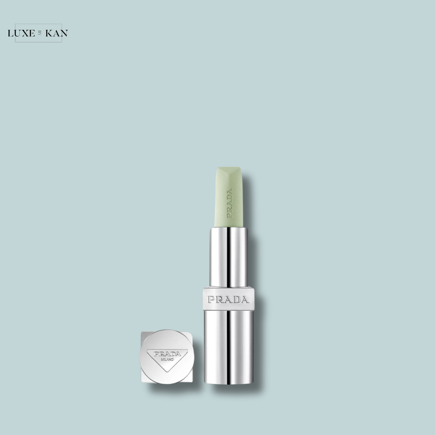 PRADA balm lip balm in a silver tube.