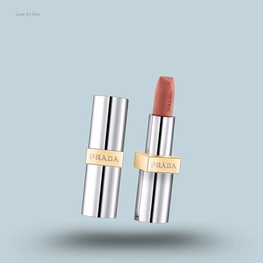 Prada hyper matte nudes refillable lipstick, with an opened silver case next to a nude lipstick.
