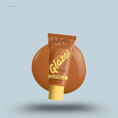 NYX Professional Makeup Buttermelt Glaze Skin Tint SPF 30 tube and swatch on blue background — LBK