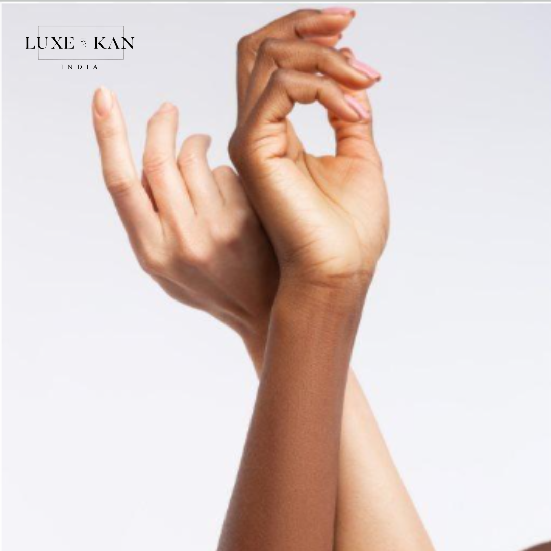 Two hands of different skin tones gracefully interlock, symbolizing diversity and unity against a soft gradient background.