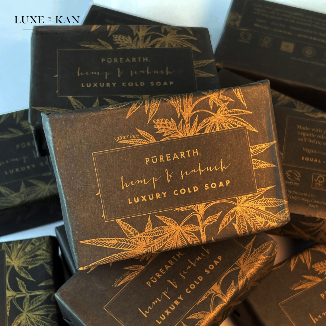 Luxurious packaging with gold floral design and text, "Pūrearth, hemp & seabuckthorn luxury Cold Soap."
