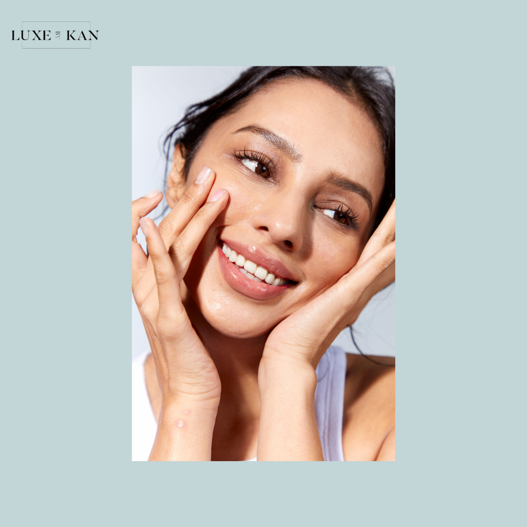 A person with hands raised near their face, showcasing smooth skin.