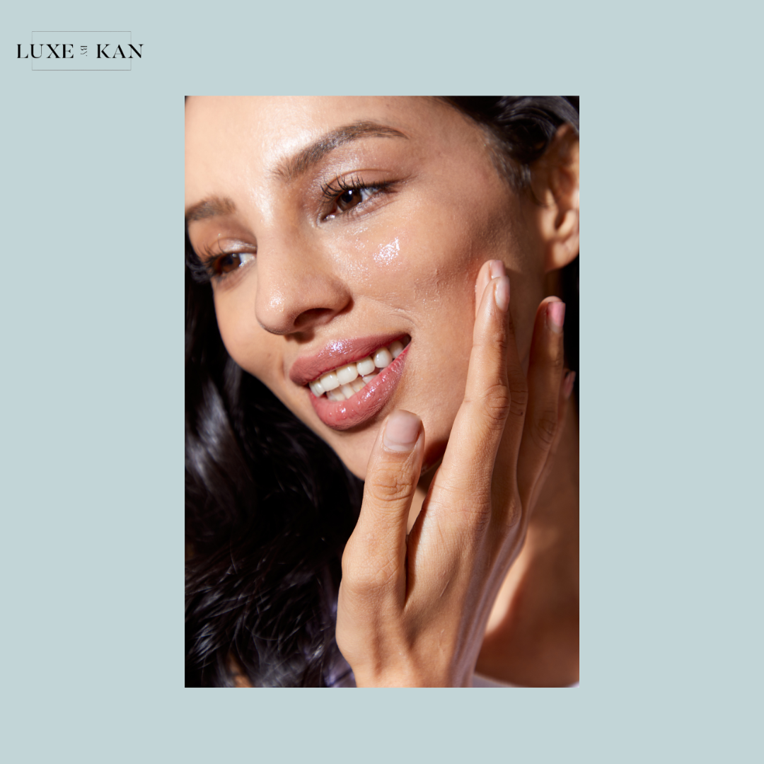 Close-up of a hand gently touching skin, with soft sunlight highlighting smooth textures and vibrant nail polish.