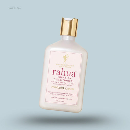 Rahua Hydration Conditioner bottle with a gold cap, featuring product information on a pink label.