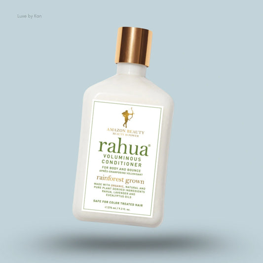 A white bottle of Rahua voluminous conditioner with a golden cap.