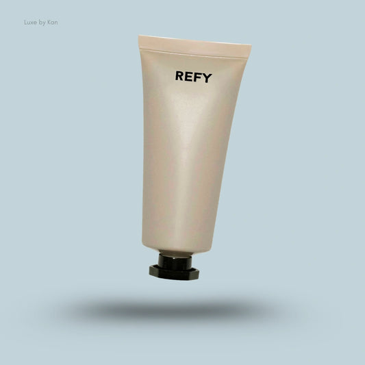 Refy body glow product in a shimmering beige tube with a black cap.