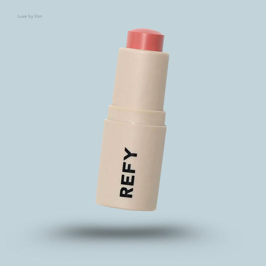 Refy Lip Blush container: beige base with the words "REFY" in dark block letters and a coral-colored top.