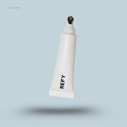 Refy tinted lip gloss in white tube with chrome applicator.